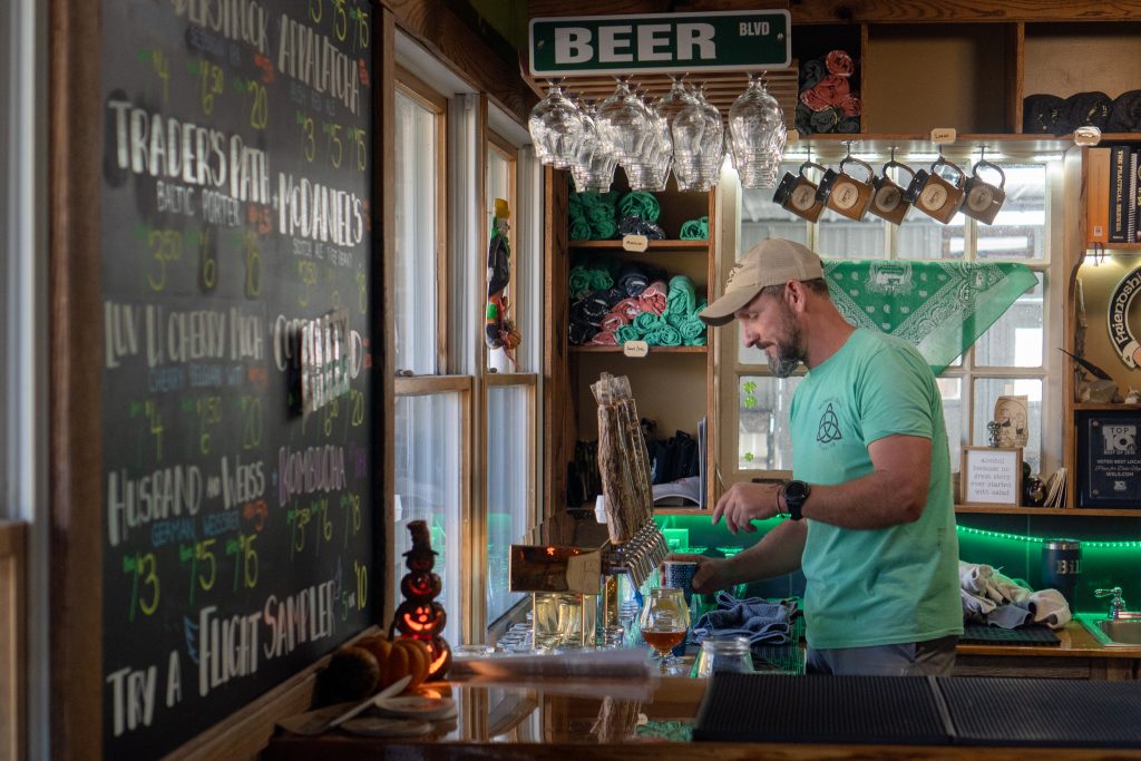 Person pouring beer at Buffalo Mountain Brewery.